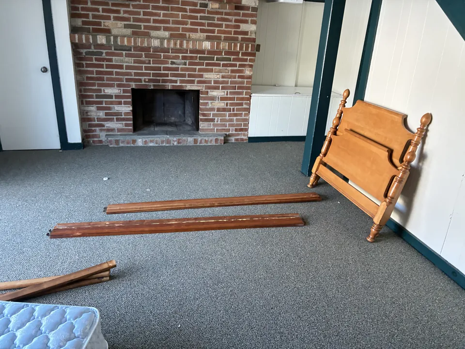 A room with an old bed frame and mattress before a TJ's cleanout